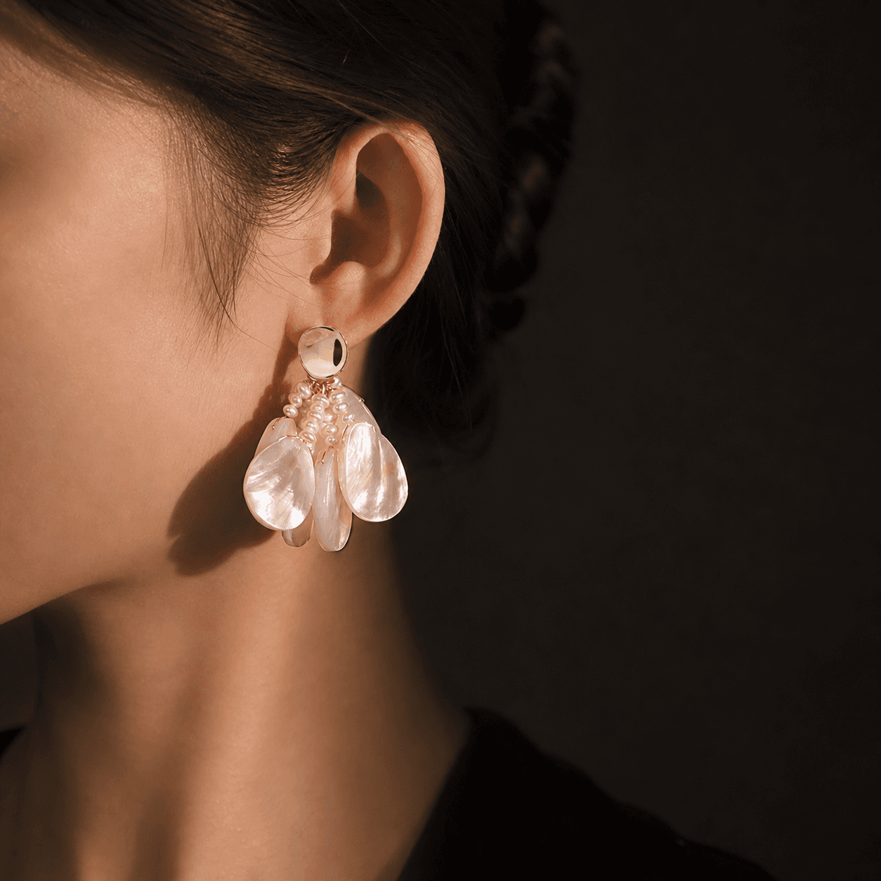 Model wearing pearl earrings